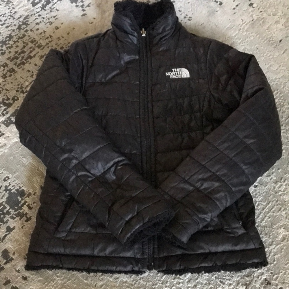 Girls black reversible The North Face coat.